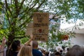 Woman in a crowd holds up a feminist protest sign at a pro-choice rally