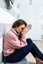 Young woman after cry sitting on whte floor at home in depression. A woman sitting alone and depressed. The depression woman sit o Royalty Free Stock Photo