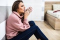 Young woman after cry sitting on whte floor at home in depression. A woman sitting alone and depressed. The depression woman sit o Royalty Free Stock Photo