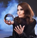 Young woman with crystal ball. Royalty Free Stock Photo