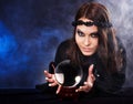 Young woman with crystal ball. Royalty Free Stock Photo