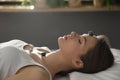 Young woman during crystal healing session in room