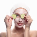 Young woman with cucumber mask