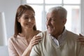 Young woman cuddling shoulders of joyful elderly mature 70s father. Royalty Free Stock Photo