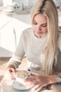 Young woman with cup of coffe in restaraunt