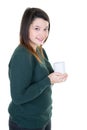 Young woman with cup of coffee looks camera