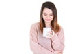 Young woman with cup of coffee looks down pensive thinking