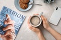 Young woman with cup of delicious hot coffee at table Royalty Free Stock Photo