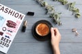 Young woman with cup of delicious hot coffee at table Royalty Free Stock Photo