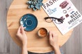 Young woman with cup of delicious hot coffee at table Royalty Free Stock Photo