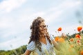 Young woman with curly hair in a field of wild flowers Royalty Free Stock Photo