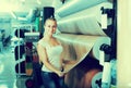 Young woman customer choosing linoleum flooring Royalty Free Stock Photo