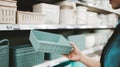 Young Woman Customer Choosing Plastic Product in Store