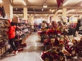 Young woman customer take from top shelve xmas decoration in specialized Christmas store