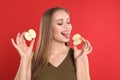 Young woman with cut apple on background. Vitamin rich food