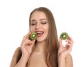 Young woman with cut kiwi on background. Vitamin rich food