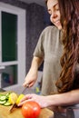 Young woman cut lemon for preparing salad in kitchen, close up Royalty Free Stock Photo