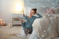 Young woman with cute cat reading book. Cozy winter Royalty Free Stock Photo