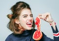 young woman or cute sexy girl holds grapefruit fruit slice, fresh summer juice. Royalty Free Stock Photo