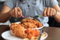 Young woman cutting fried chicken select focus, Fried chicken lunch, Close-up woman hands cutting fried chicken, Eat fried chicken Royalty Free Stock Photo