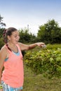 Young woman cutting and pruning the maple tree (Acer laurinum) Royalty Free Stock Photo