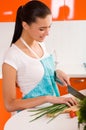 Young woman cutting vegetables in a kitchen Royalty Free Stock Photo