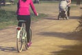 A young woman is cycling into the sunset in the park Royalty Free Stock Photo