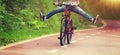 Woman cyclist fun riding bike on forest trail Royalty Free Stock Photo