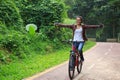 Woman cyclist fun riding bike on forest trail Royalty Free Stock Photo