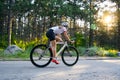 Young Woman Cyclist Riding Road Bicycle on the Free Road in the Forest at Hot Summer Day. Healthy Lifestyle Concept. Royalty Free Stock Photo