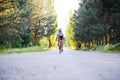 Young Woman Cyclist Riding Road Bicycle on the Free Road in the Forest at Hot Summer Day. Healthy Lifestyle Concept Royalty Free Stock Photo