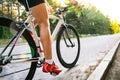 Young Woman Cyclist Riding Road Bicycle on the Free Road in the Forest at Hot Summer Day. Healthy Lifestyle Concept Royalty Free Stock Photo