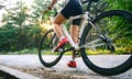 Young Woman Cyclist Riding Road Bicycle on the Free Road in the Forest at Hot Summer Day. Healthy Lifestyle Concept Royalty Free Stock Photo