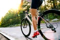 Young Woman Cyclist Riding Road Bicycle on the Free Road in the Forest at Hot Summer Day. Healthy Lifestyle Concept. Royalty Free Stock Photo