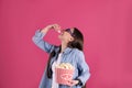 Young woman with 3D glasses eating tasty popcorn Royalty Free Stock Photo