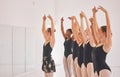 Young woman dance instructor teaching a ballet class to a group of a children in her studio. Ballerina teacher working Royalty Free Stock Photo