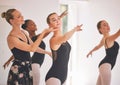 Young woman dance instructor teaching a ballet class to a group of a children in her studio. Ballerina teacher working Royalty Free Stock Photo