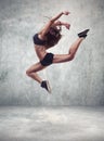 Young woman dancer with grunge wall background Royalty Free Stock Photo