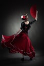 Young woman dancing flamenco on black Royalty Free Stock Photo