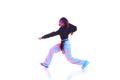 Young woman dancing hip hop, breakdance, dance hall isolated over white background in neon light Royalty Free Stock Photo