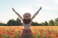 Young woman dancing on poppy field from back Royalty Free Stock Photo