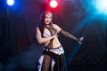 Young woman dancing in Tribal Fusion style. Belly dance on the stage.