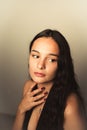 Young woman with dark eyes averted away from the camera wearing a black dress Royalty Free Stock Photo