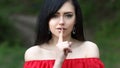 Young woman with dark long hair saying shh with forefinger on lips. silence gesture Royalty Free Stock Photo