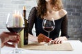 Young woman drinking red wine on a date in a restaurant Royalty Free Stock Photo