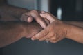 Young woman daughter granddaughter caregiver holding old senior female hand helping elderly mother as concept of older people Royalty Free Stock Photo