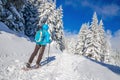 Young woman in dawn jacket hiking on snow shoes