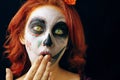 A young woman in day of the dead mask skull face art.