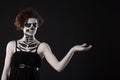 Young woman in day of the dead mask skull face art. Halloween face art with fog on black background Royalty Free Stock Photo