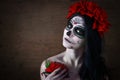 Day of the dead. Halloween. Young woman in day of the dead mask skull face art and rose. Dark background. Royalty Free Stock Photo